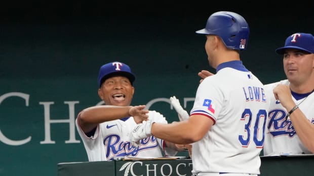 Aug 18, 2022; Arlington, Texas, USA; Texas Rangers first baseman Nathaniel Lowe (30) is congratulated by interim manager Tony Beasley (27) as he arrives to the dugout after hitting a three-run home run against the Oakland Athletics during the fifth inning at Globe Life Field. Mandatory Credit: Jim Cowsert-USA TODAY Sports